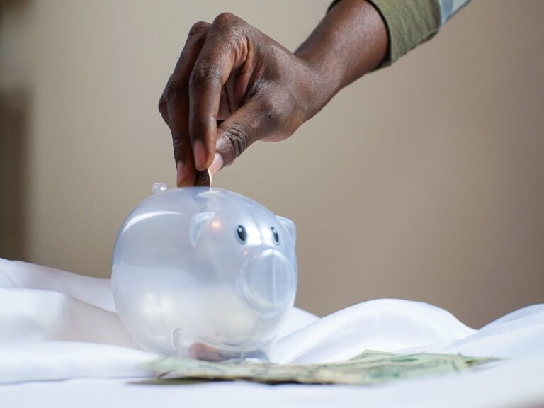 person putting change into a jar