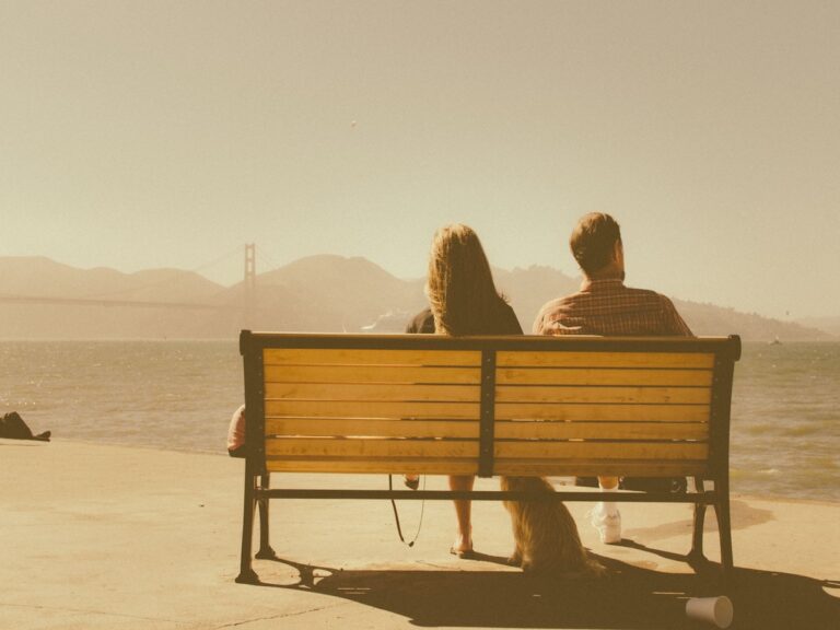 couple sitting on a bench not speaking